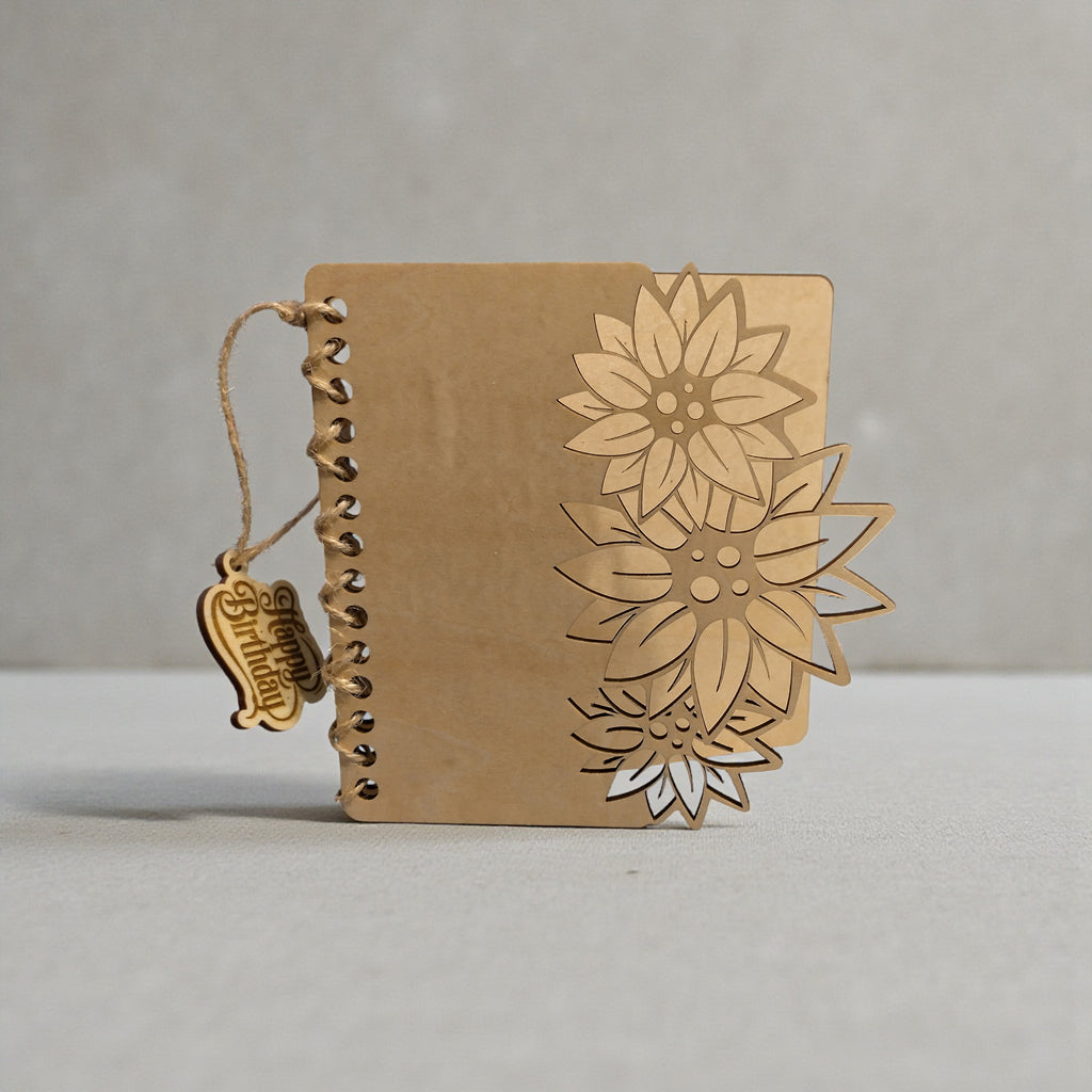 Personalised wooden birthday card closed, featuring a layered 3D sunflower design and twine binding with a hanging “Happy Birthday” tag.