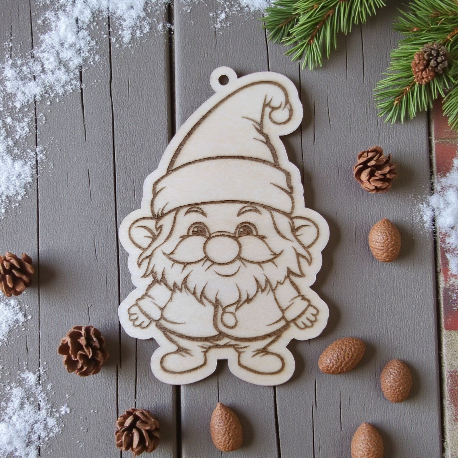 Santa Claus ornament with hat and beard, engraved on natural wood.