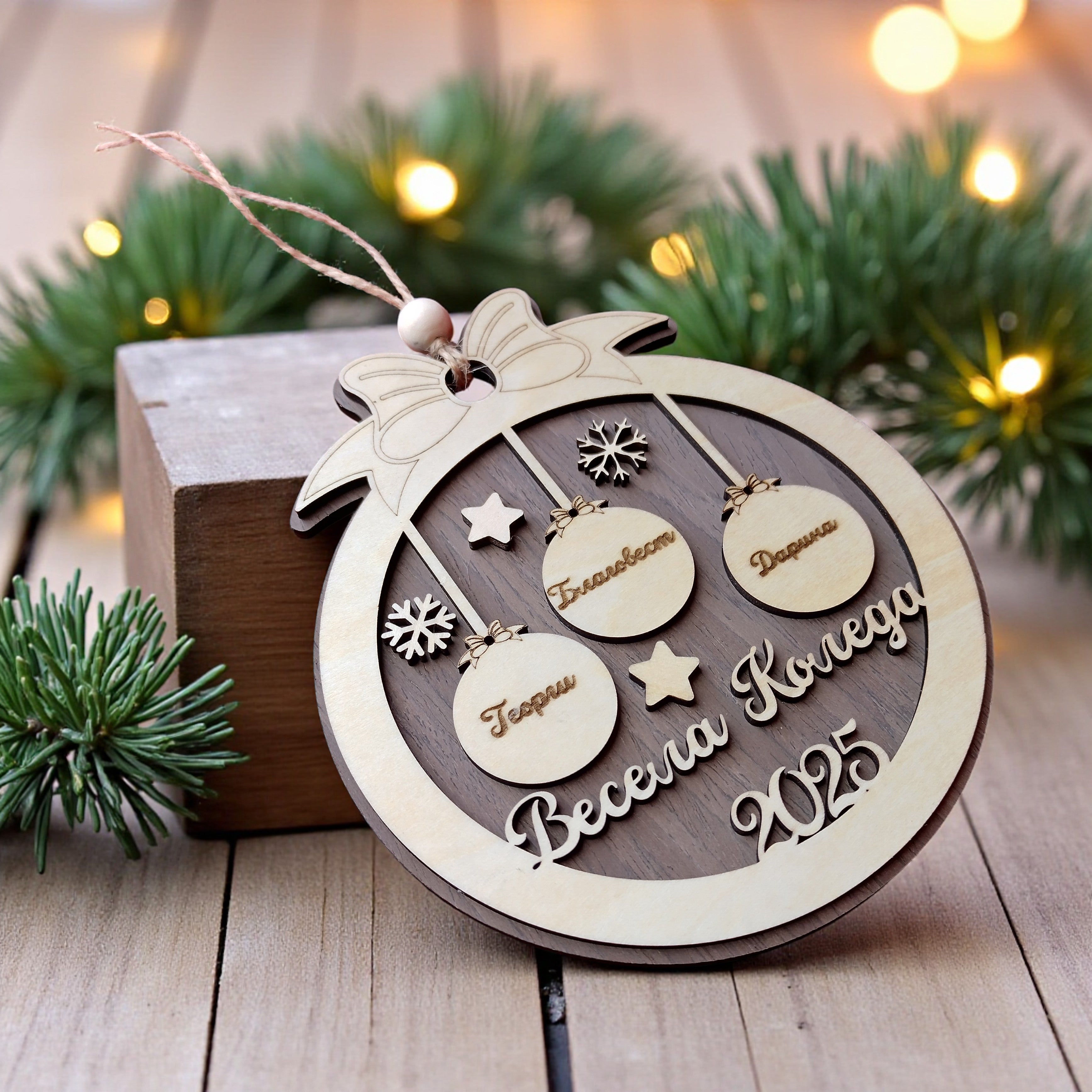 Engraved birch wood Christmas bauble featuring family names and stars – personalised festive ornament handmade in the UK
