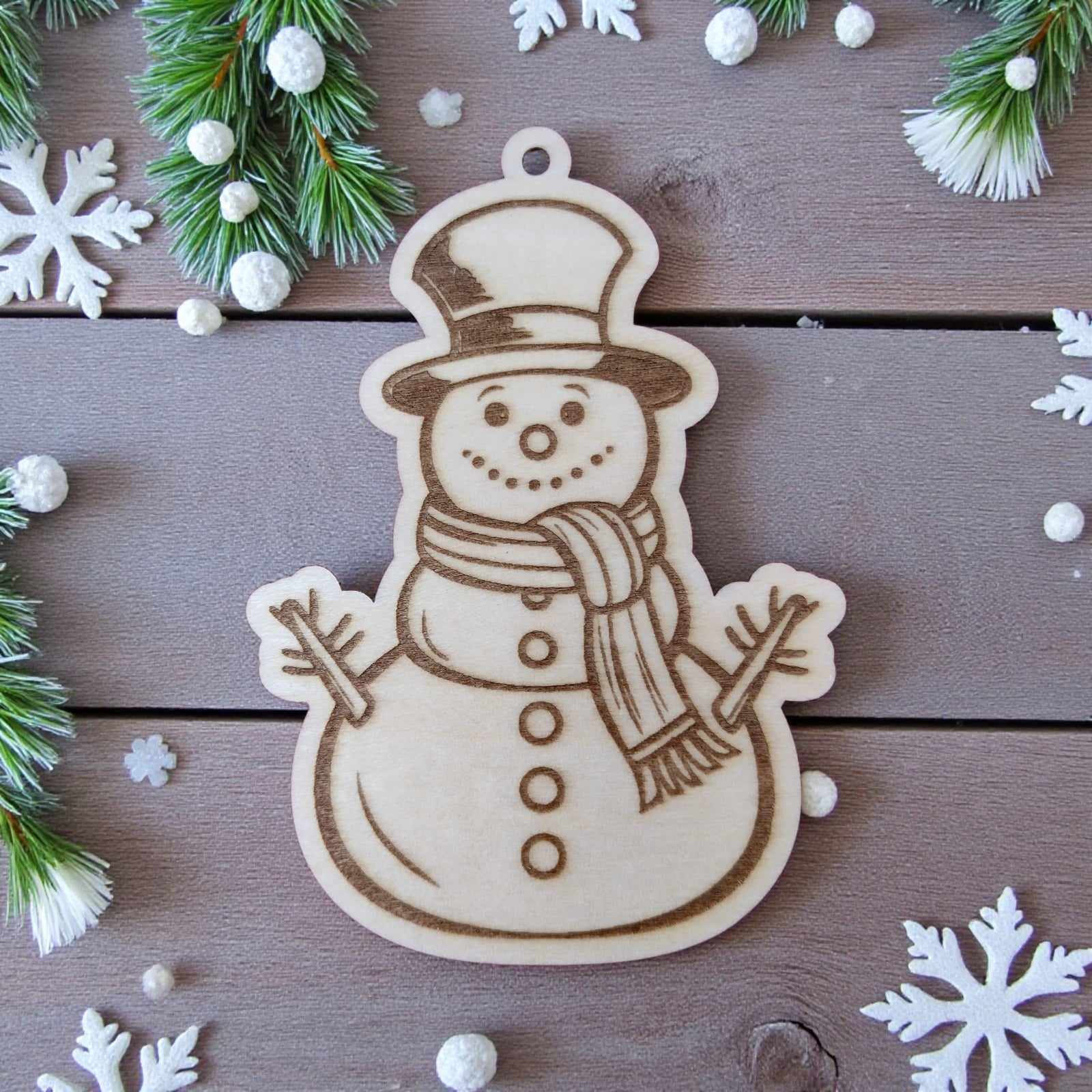 Happy snowman wooden ornament, wearing scarf and top hat, winter decor.