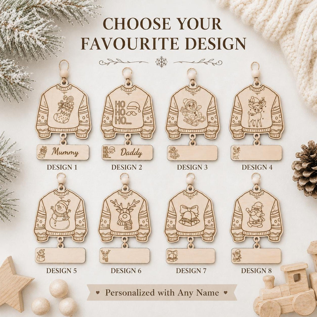 A product display graphic showing eight personalized wooden hanging ornaments shaped like sweaters, labeled Design 1 through Design 8, with blank name plates underneath. The image includes decorative holiday props such as pine branches, a knitted sweater, a pinecone, and a small wooden train, with the headline 'CHOOSE YOUR FAVOURITE DESIGN' at the top.