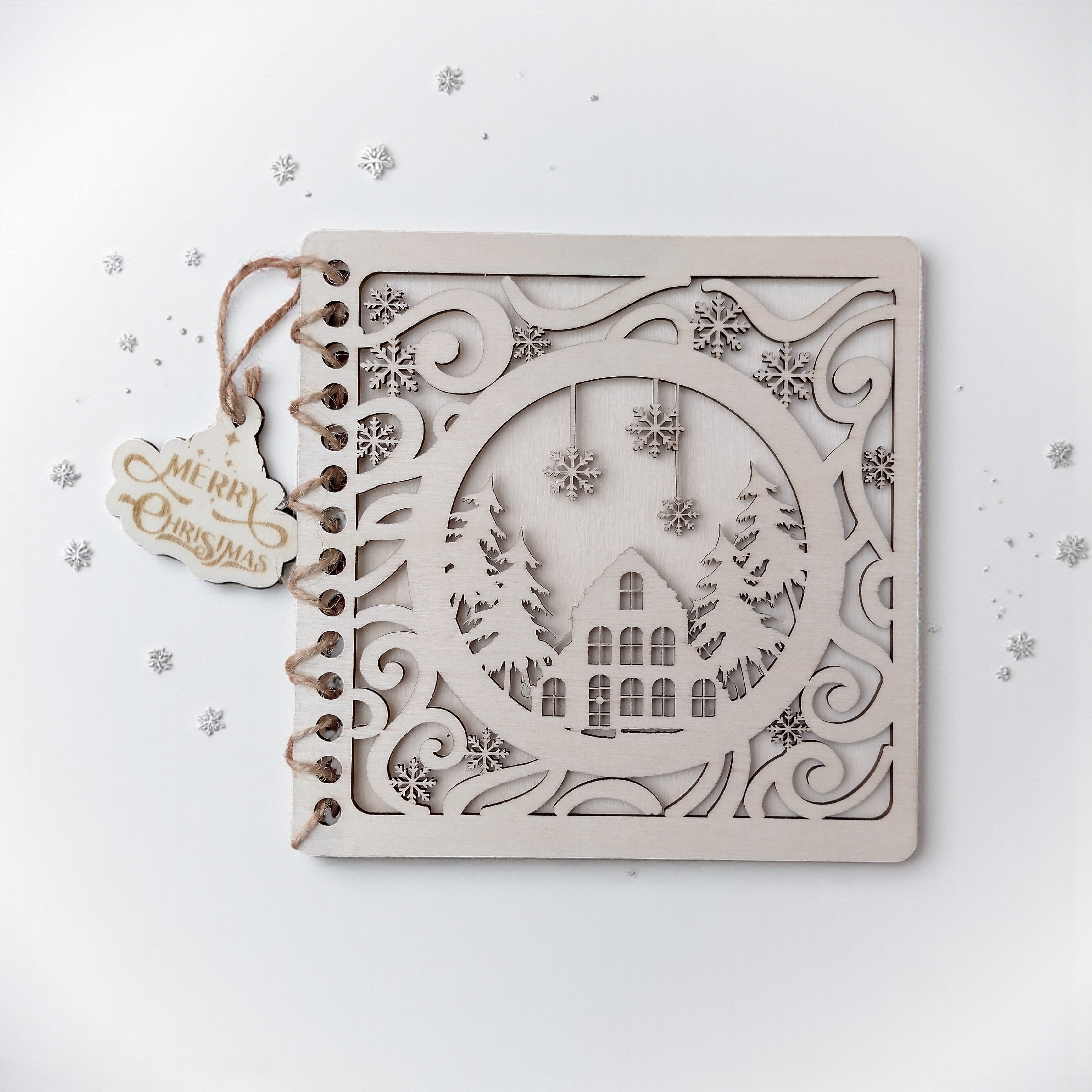Alt: Handmade wooden Christmas card with laser-cut winter house and snowflakes design on birch wood – CraftRay Gifts.