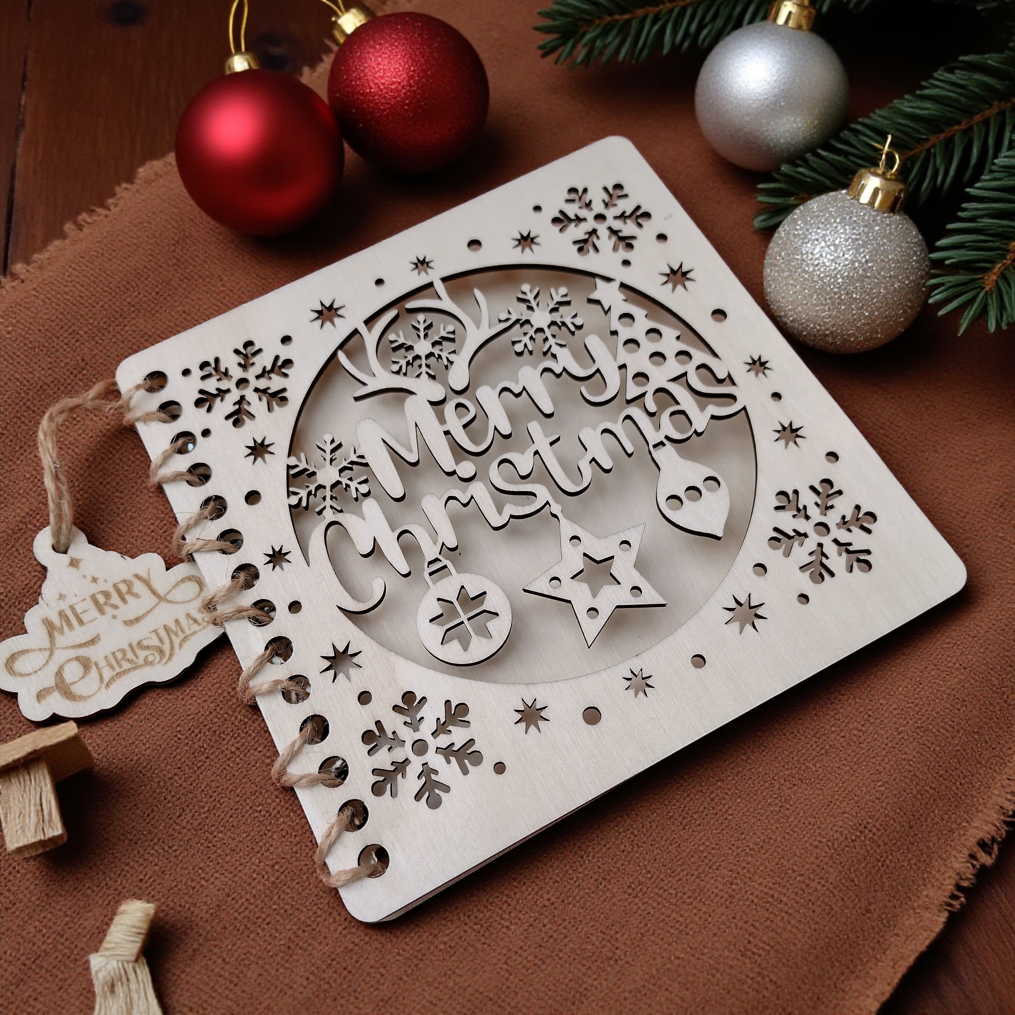 Rustic wooden Christmas card with engraved snowflakes and ornaments, handmade eco-friendly festive greeting card.