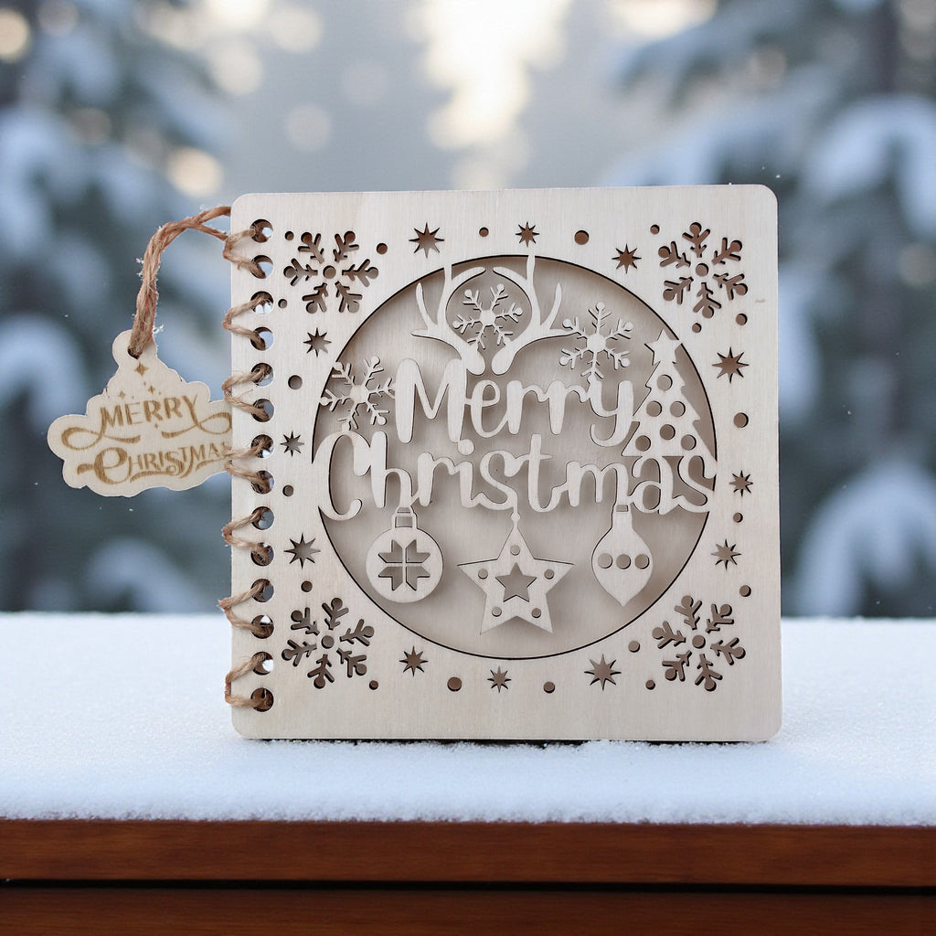 Wooden “Merry Christmas” card displayed outdoors on snow, laser-cut festive card made from sustainable wood.