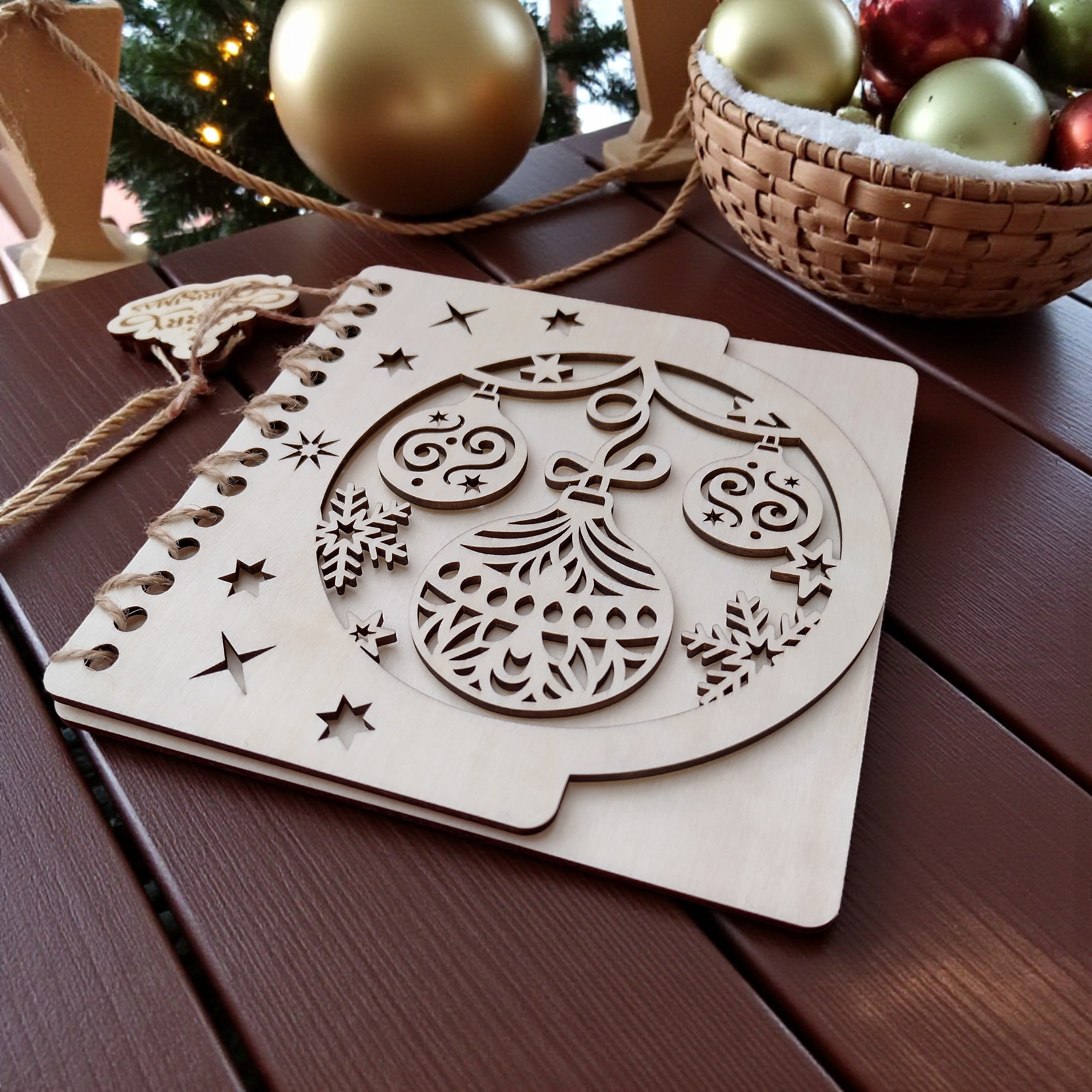 Rustic wooden Christmas card with ornaments and gold baubles, festive flat lay