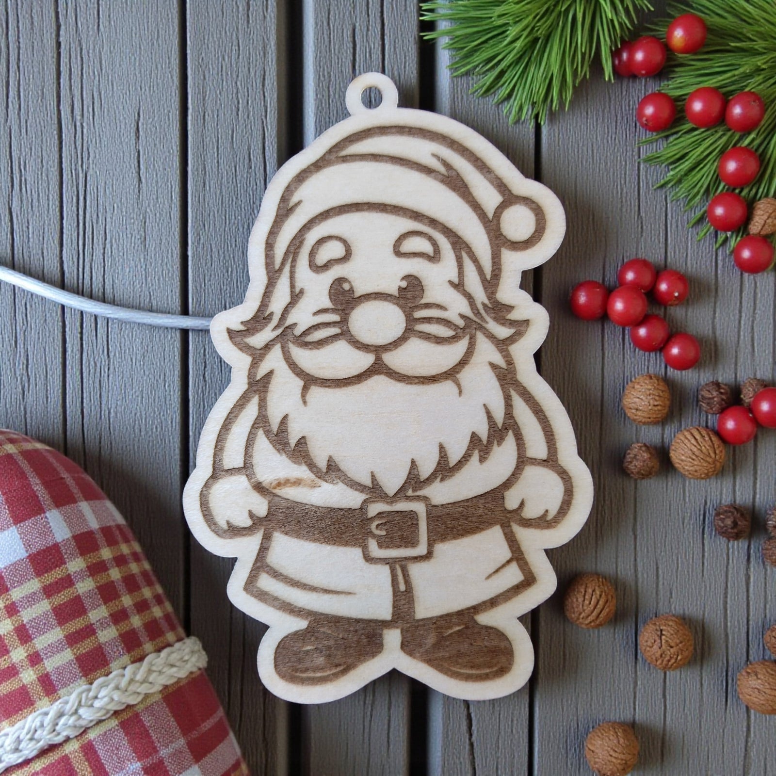 Santa Claus wooden ornament with belt and hat, engraved festive decoration.