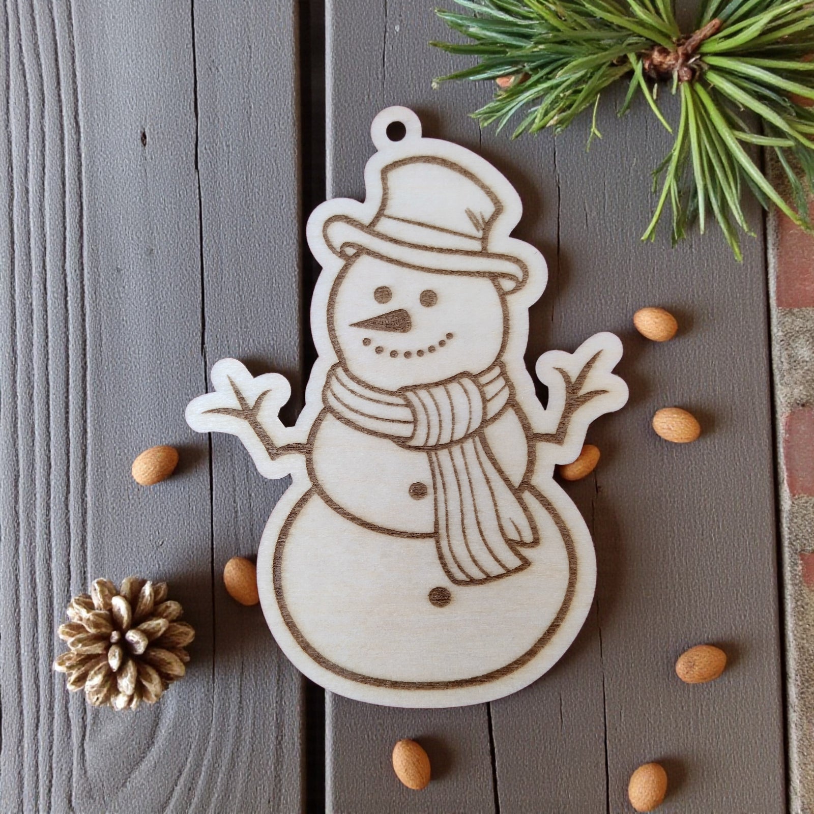 Snowman wooden ornament with scarf and hat, engraved Christmas decoration.