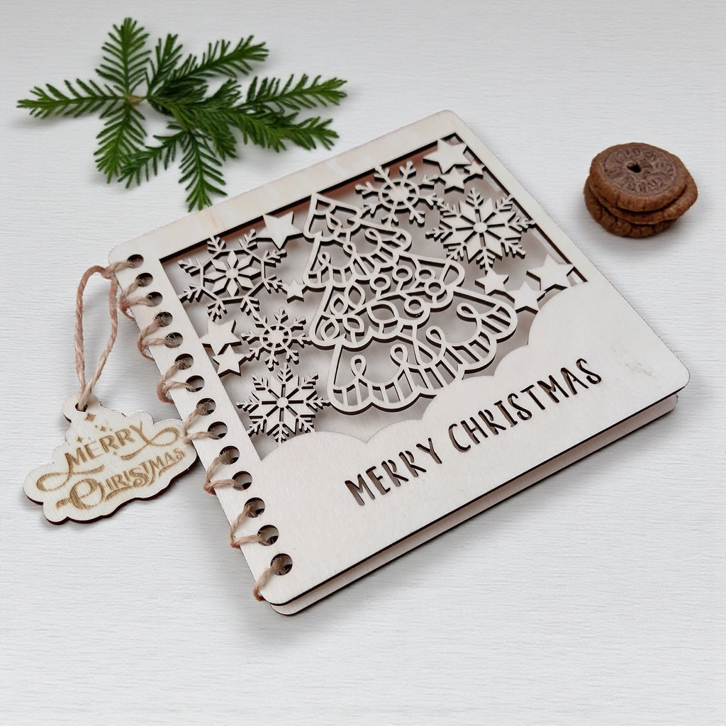 1️⃣ Wooden Christmas card with laser-cut tree and snowflakes – rustic handmade design.
