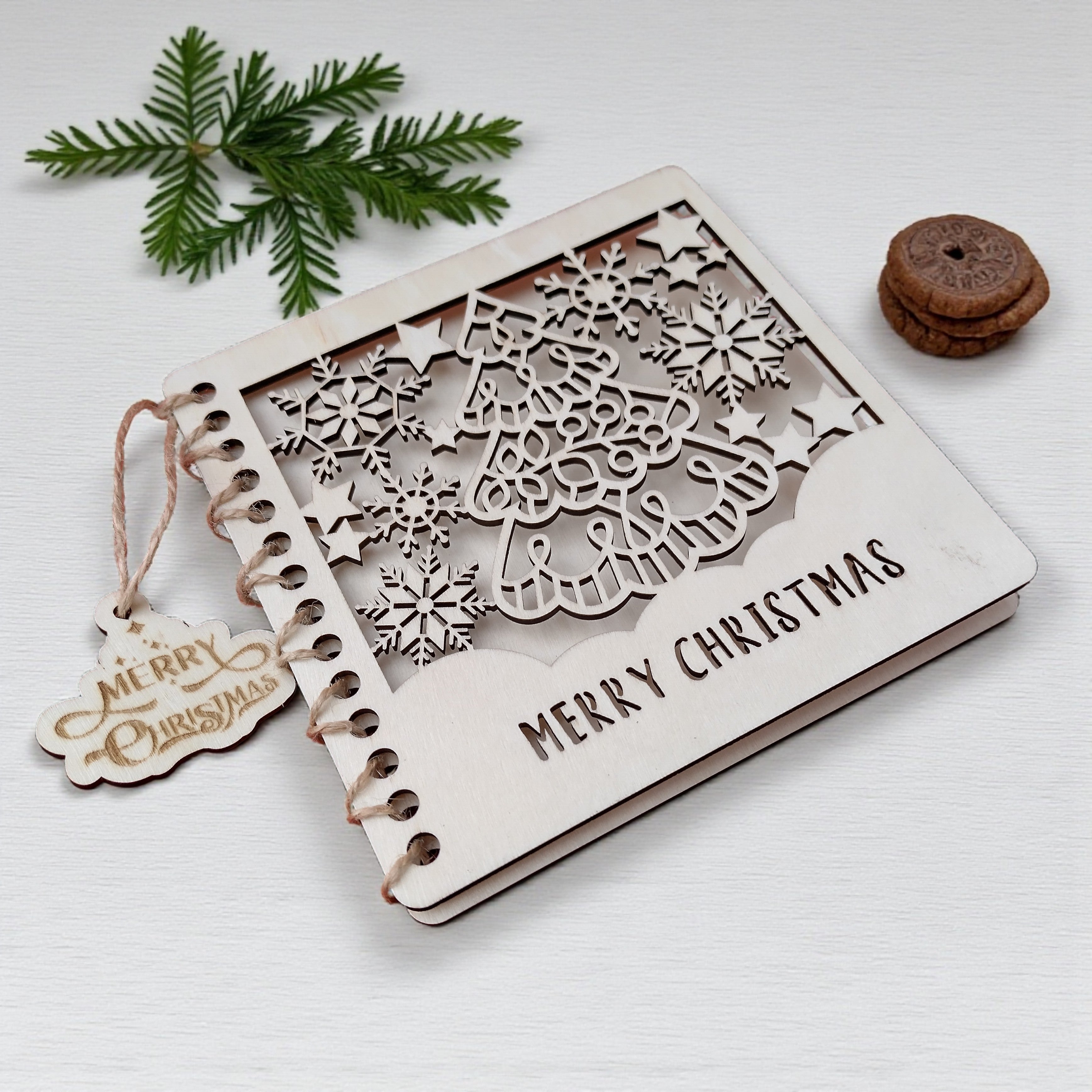 1️⃣ Wooden Christmas card with laser-cut tree and snowflakes – rustic handmade design.
