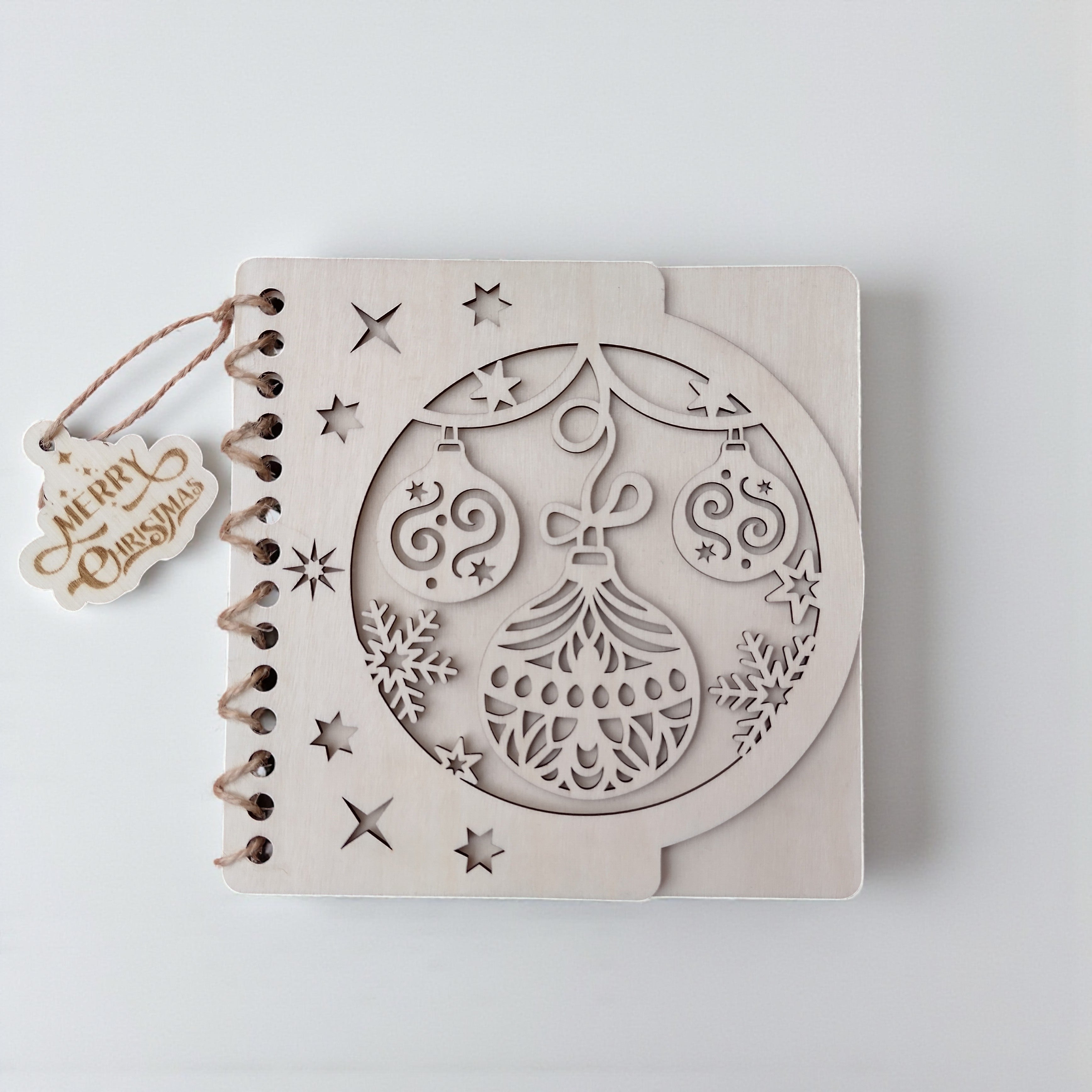 Wooden Christmas card with laser-cut ornament design on white background