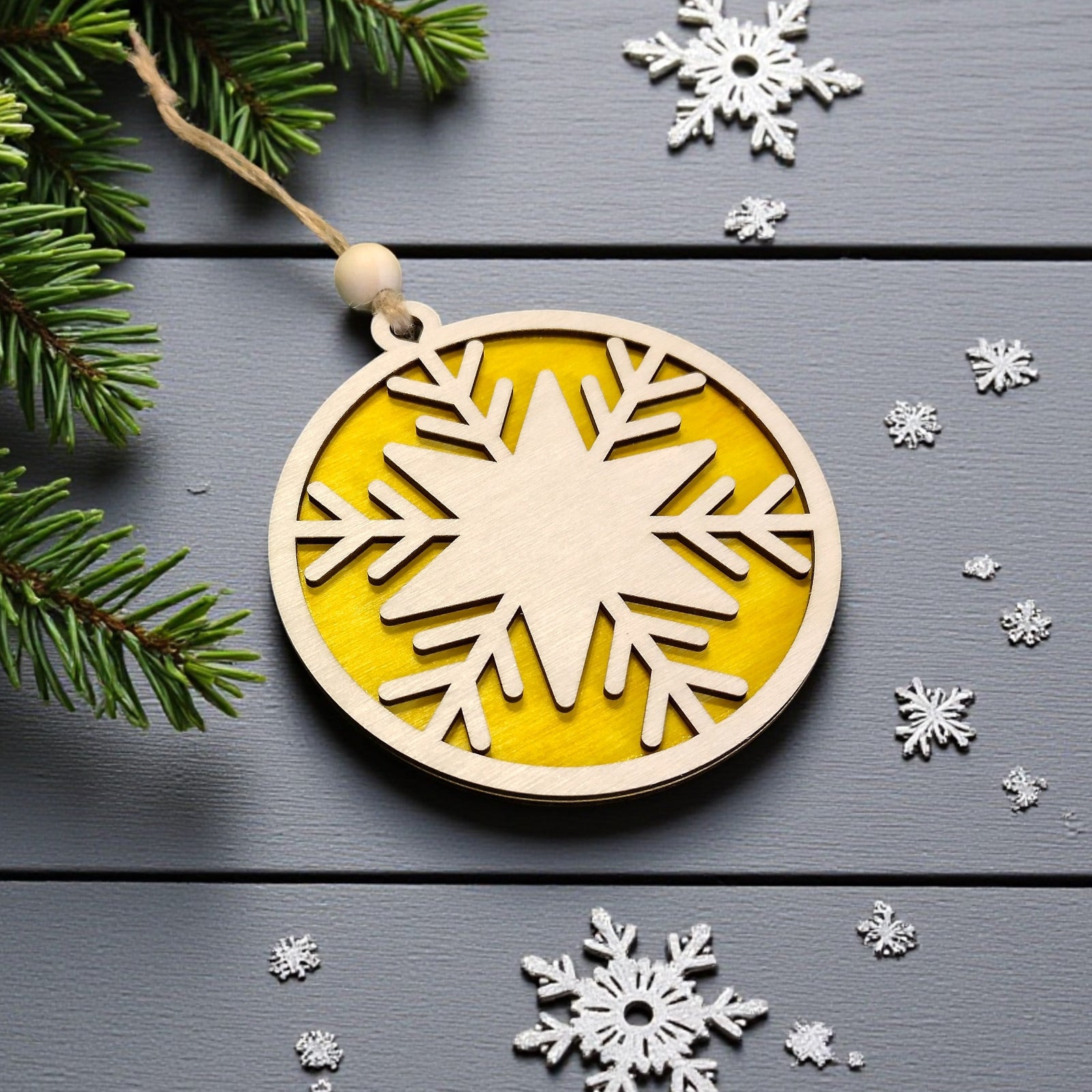 Wooden Christmas ornament with yellow background and snowflake cutout – festive handmade decor by CraftRay Gifts.